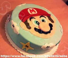 a birthday cake decorated with an image of mario