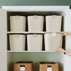 the shelves are filled with baskets and labels