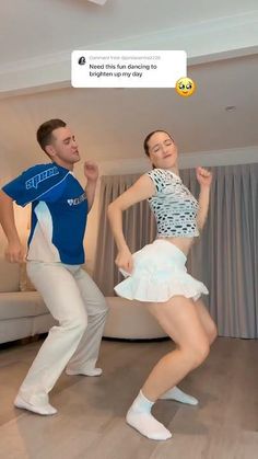 a man and woman are dancing in the living room with emoticions on their faces