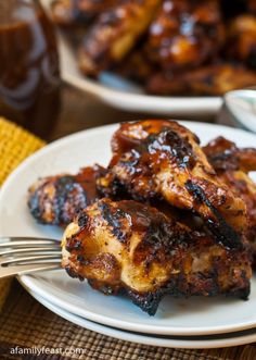 grilled chicken on a white plate with a fork