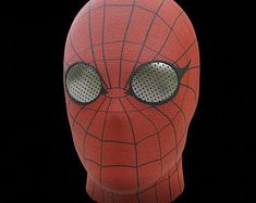 a close up of a spiderman mask on a black background