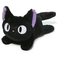 a black cat stuffed animal laying on its side with eyes wide open and one eye partially closed