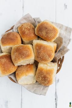 a basket full of bread rolls sitting on top of a table