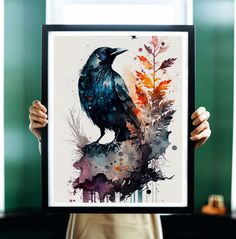 a person holding up a framed painting with a black bird on it's head