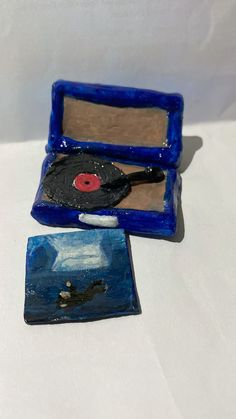 two pieces of pottery sitting on top of a white table