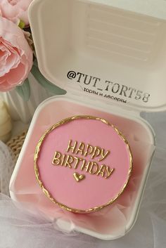 a pink and gold birthday cake in a white box with the words happy birthday on it