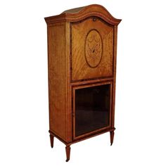 an old fashioned wooden cabinet with a clock on it's front and side panels