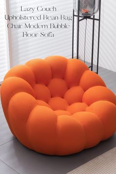 an orange chair sitting on top of a white floor