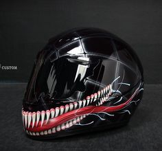 the helmet is decorated with an image of a monster's mouth and teeth on it