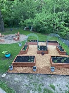 an outdoor garden area with raised beds and chairs