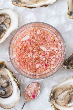 a bowl filled with lots of food next to oysters