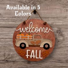 a wooden sign that says welcome fall with an old truck and pumpkins on it