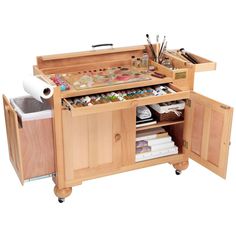 an arts and crafts workbench with lots of crafting supplies on it's drawers