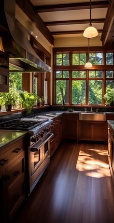 a kitchen with wood floors and large windows overlooking the trees in the distance is shown