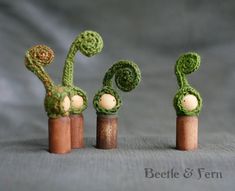 three small crocheted plants are sitting on top of each other