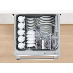 an open dishwasher with dishes in it on a wood floored surface and white walls