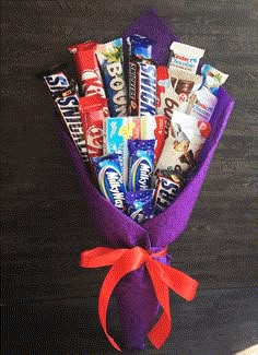 a bouquet of candy wrapped in purple paper