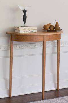 a wooden table with books and pears on it