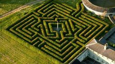 an aerial view of a large maze in the grass