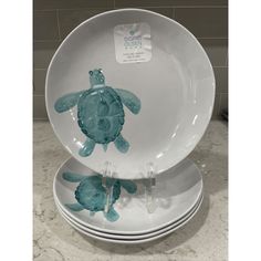 three plates stacked on top of each other with sea turtles painted on the front and sides