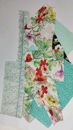 four pieces of fabric are laid out on top of each other, including one with flowers