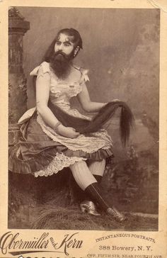 an old photo of a man with a long beard sitting on top of a chair