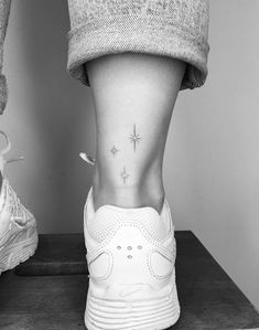 a woman's foot with a small star tattoo on her left side ribcage