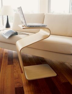 a laptop computer sitting on top of a white couch