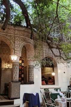 an outdoor dining area with tables and chairs