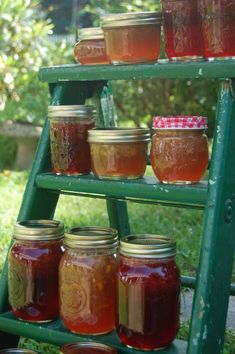 there are many jars that are on the shelf in front of each other and one is filled with jam