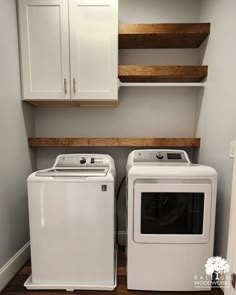 a white washer and dryer sitting next to each other in a laundry room