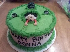 a green birthday cake with a sheep on top and happy birthday donna written on the side