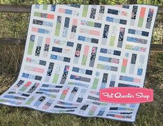 a quilt on the grass with text that reads triples quilt kit