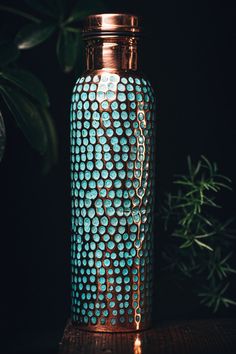 a blue vase sitting on top of a wooden table