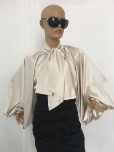 "This is a very stylish Womens Silk satin Blouse. It is comfortable and cozy. Made for a free flowing fit. Great for all year around and for any special occasion or casual day can be dressed up or dressed down. SIZE CHART SIZE S - US 6, UK 8, EU 36 bust: bust around 34.5\"/90cm Waist: waist around 27.5\"/70cm Hips: hips around 34.5\"/90cm SIZE M - US 8, UK 10, EU 38 bust: bust around 37.5\"/95cm Waist: waist around 29.5\"/75cm Hips: hips around 37.5\"/95cm SIZE L - US 10, UK 12, EU 40 bust: bust Elegant Satin Blouse For Office, Evening Tie Neck Top With Bow, Elegant Evening Satin Blouse, Elegant Spring Tops With Satin Bow, Elegant Tops With Satin Bow For Spring, Fitted Satin Tie Neck Top, Fall Party Blouse With Tie Neck, Fall Party Tie Neck Blouse, Fitted Tops With Satin Bow