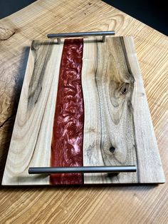 a wooden cutting board with red and white strips on it