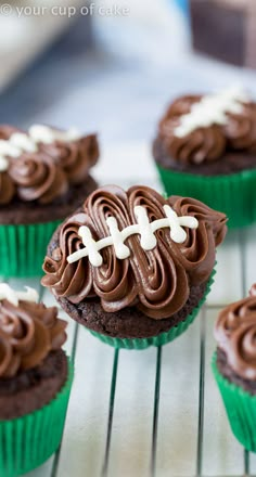 cupcakes with chocolate frosting and white crosses on them