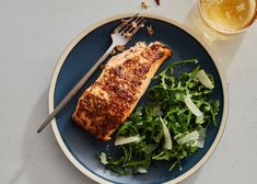 a piece of fish and greens on a plate