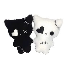 two black and white stuffed animals with hearts on their eyes, one is wearing a skull face