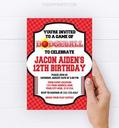 a person holding up a red and white birthday card with the words, you're invited to a game of dodgeball to celebrate