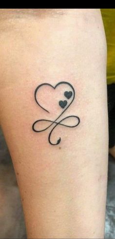 a small heart tattoo with two hearts in the middle and an arrow at the bottom