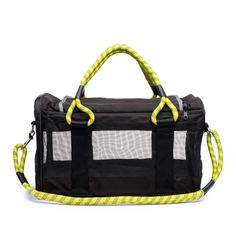 a black and yellow dog carrier with rope handles on the handle, in front of a white background