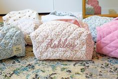 several blankets are laying on the floor next to each other and one has a name written on it