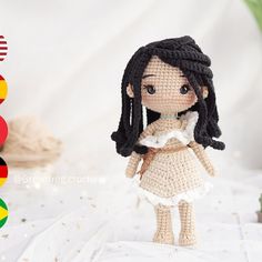 a crocheted doll is standing next to a potted plant and some other decorations