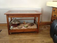 a wooden table with an animal bed underneath it