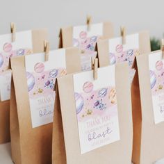 small brown bags with thank you tags attached to the handles are lined up on a table