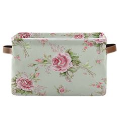 a floral print cosmetic bag with brown leather handles