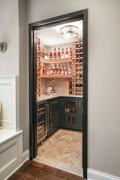 an open wine cellar with lots of bottles in it's walls and shelves on either side