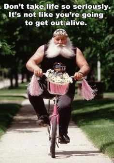 a man riding a bike down a sidewalk with a cupcake in front of him