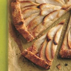 an apple pie is cut into slices on a cutting board